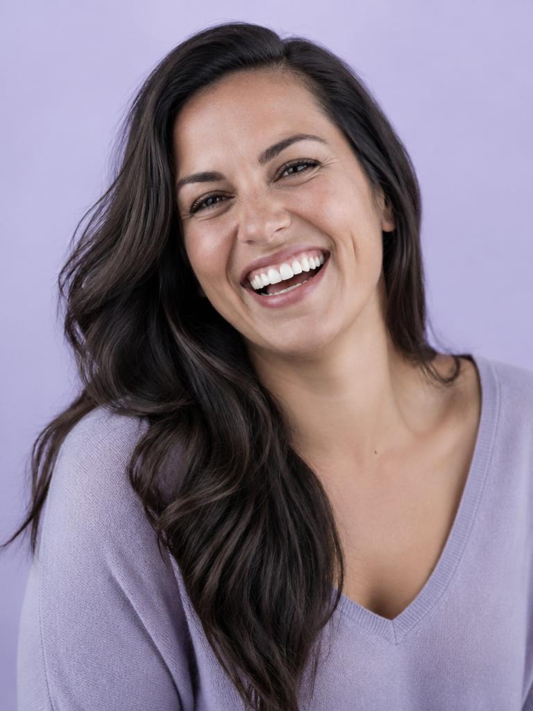 Illustrative sample: young woman laughing naturally